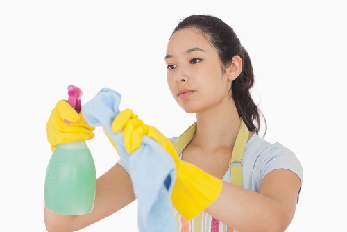 Cleaner working on residential windows in Putney with careful access